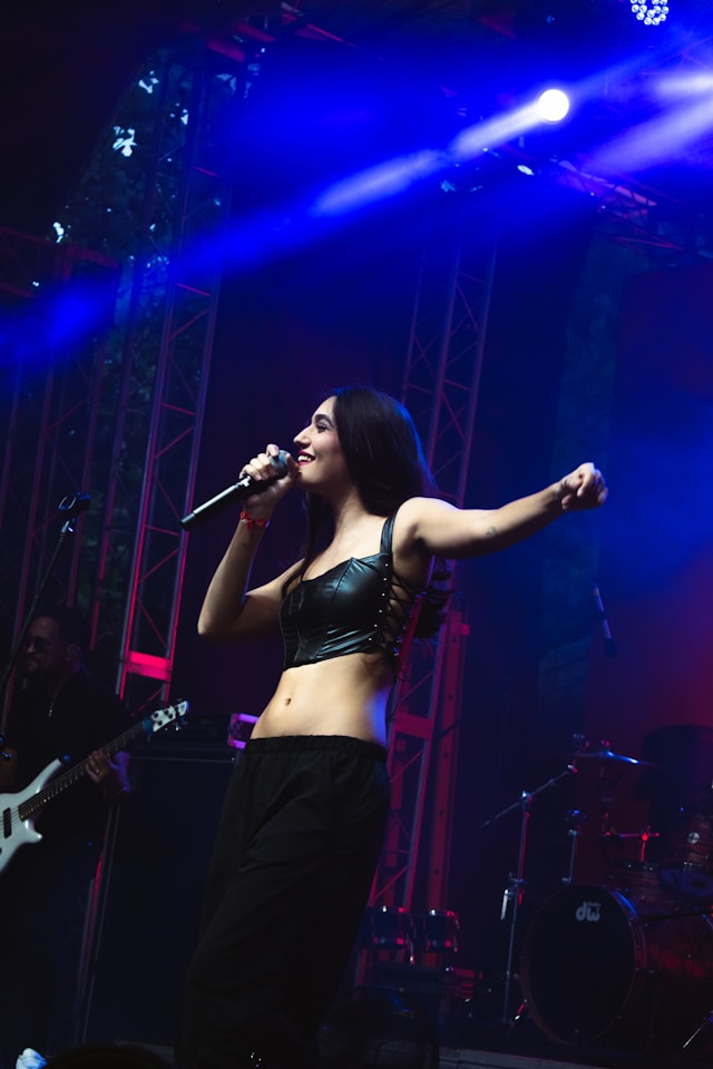 Band Member AJ on stage - cast in a blue light