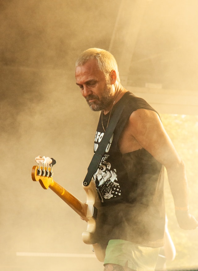 Band Member Blax on stage - cast in a yellow light
