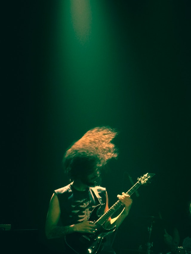 Band Member Joey on stage - cast in a green light